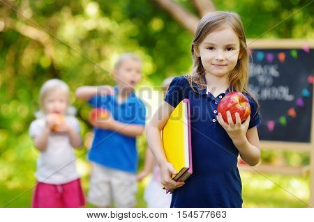 Adorable little schoolgirl feeling extremely excited about going back to school
