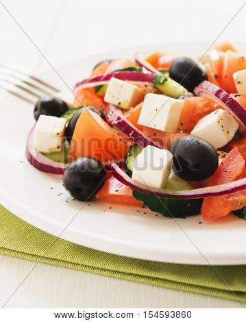 Classic greek salad. Salad with tomato cucumber red onion black olives and fresh feta cheese selective focus