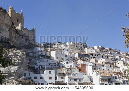 Alcala del Jucar Spain - October 29 2016: Side view of the village on top of limestone mountain is situated Castle of the 12TH century Almohad origin take in Alcala of the Jucar Albacete province Spain