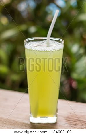Sugarcane Juice With Piece Of Sugarcane On Wooden Background