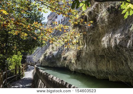 Alcala del Jucar Spain - October 29 2016: Passage along the river Jucar during autumn take in Alcala of the Jucar Albacete province Spain