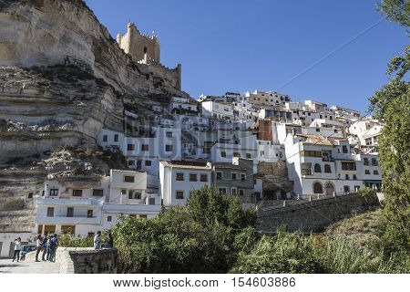 Alcala del Jucar Spain - October 29 2016: Roman bridge located in the central part of the town to its passage by the river Jucar at the top of mountain limestone is situated castle of Almohad origin of the century XII take in Alcala of the Jucar Albacete