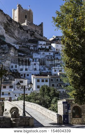 Alcala del Jucar Spain - October 29 2016: Roman bridge located in the central part of the town to its passage by the river Jucar at the top of mountain limestone is situated castle of Almohad origin of the century XII take in Alcala of the Jucar Albacete