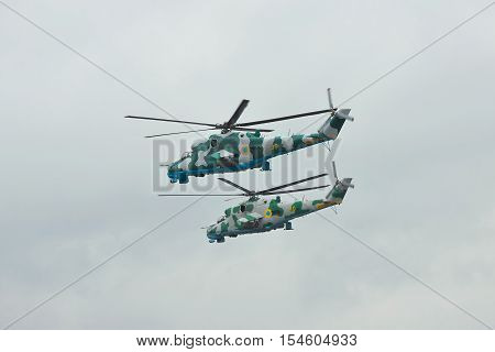 Zhitomir Ukraine - September 29 2010: A pair of Ukrainian Army Mi-24 attack helicopters in flight during military trainings in rainy weather