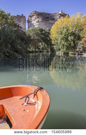 Jucar river boat of recreation in small lagoon in the central part of the town at the top of mountain limestone is situated castle of Almohad origin of the century XII take in Alcala of the Jucar Albacete province