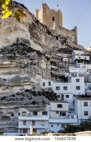 Alcala del Jucar Spain - October 29 2016: Side view of the village on top of limestone mountain is situated Castle of the 12TH century Almohad origin take in Alcala of the Jucar Albacete province Spain