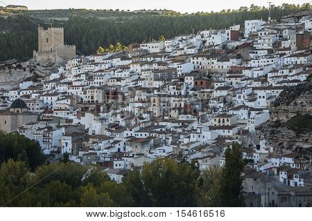 Alcala del Jucar Spain - October 29 2016: Panoramic view of the city on top of limestone mountain is situated Castle of the 12TH century Almohad origin take in Alcala of the Jucar Albacete province Spain