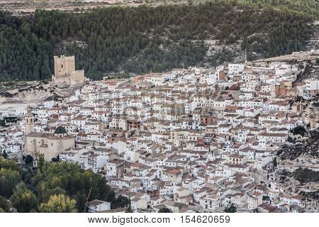 Alcala del Jucar Spain - October 29 2016: Panoramic view of the city on top of limestone mountain is situated Castle of the 12TH century Almohad origin take in Alcala of the Jucar Albacete province Spain