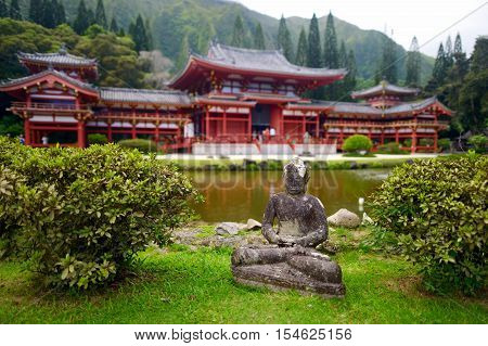 Gray Buddha Statue In Front Of Buddhist Temple