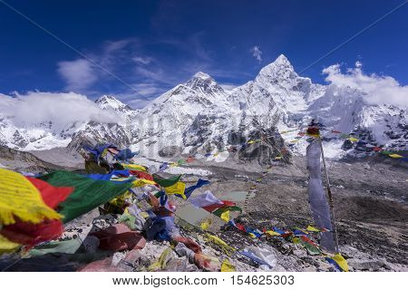 Beautiful Landscape of Everest and Lhotse peak with colorful Nepali flag as foreground from Kala Pattar view point. Gorak Shep. During the way to Everest base camp. Sagarmatha national park. Nepal.