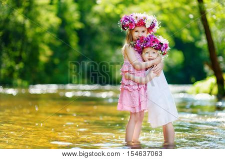 Two Little Sisters Wearing Flower Crowns