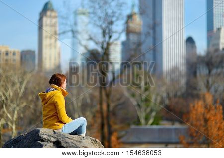 Young Woman Looking At Skyscrapers In Central Park