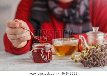 man hold the fruity jam in spoon
