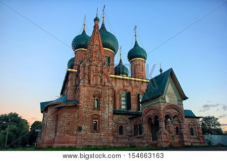 old beautiful red-brick Russian Orthodox Church with its green domes of the 16th century in Yaroslavl