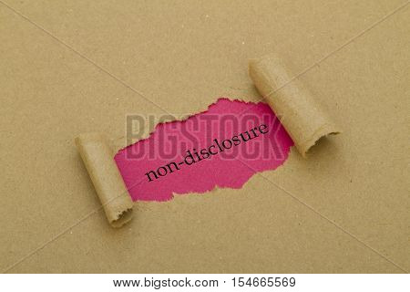 Non-Disclosure word written under torn paper .