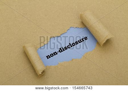 Non-Disclosure word written under torn paper .