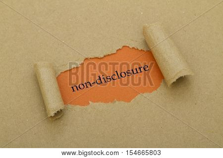 Non-Disclosure word written under torn paper .