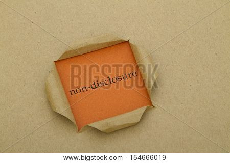 Non-Disclosure word written under torn paper .