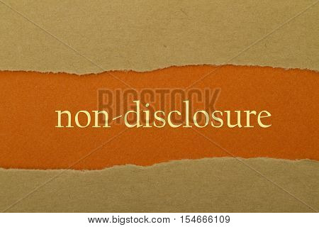Non-Disclosure word written under torn paper .
