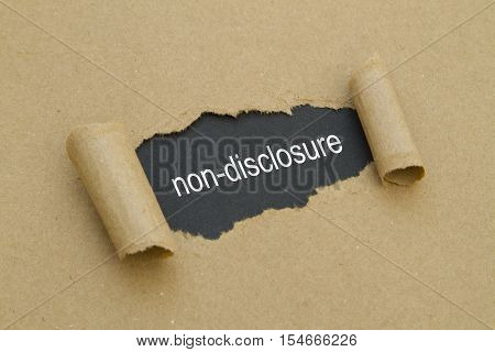 Non-Disclosure word written under torn paper .
