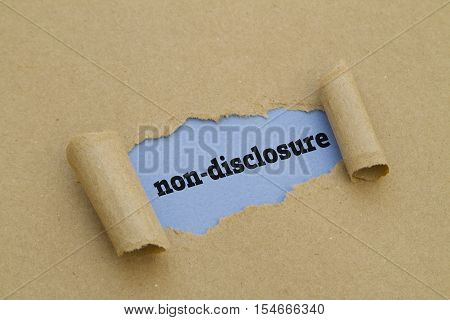 Non-Disclosure word written under torn paper .