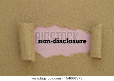 Non-Disclosure word written under torn paper .