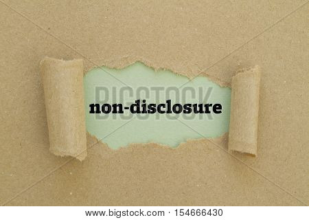 Non-Disclosure word written under torn paper .