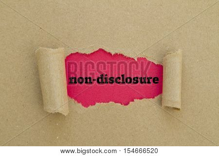Non-Disclosure word written under torn paper .