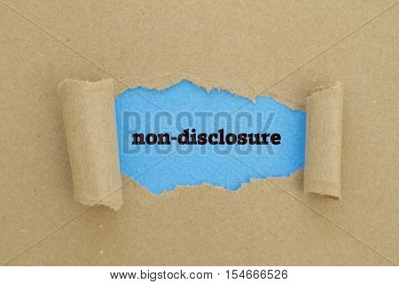 Non-Disclosure word written under torn paper .