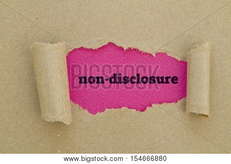 Non-Disclosure word written under torn paper .