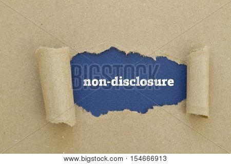 Non-Disclosure word written under torn paper .