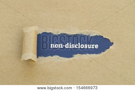Non-Disclosure word written under torn paper .