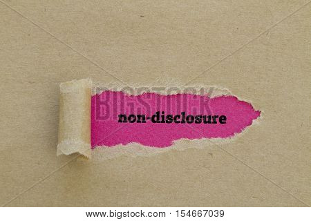 Non-Disclosure word written under torn paper .
