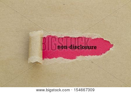 Non-Disclosure word written under torn paper .