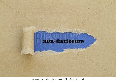 Non-Disclosure word written under torn paper .