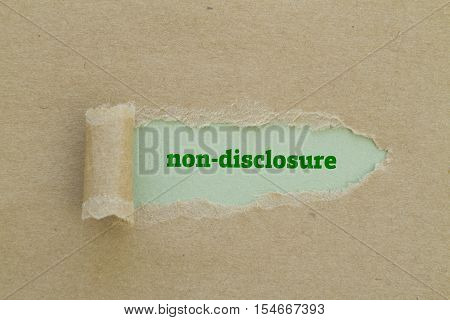 Non-Disclosure word written under torn paper .