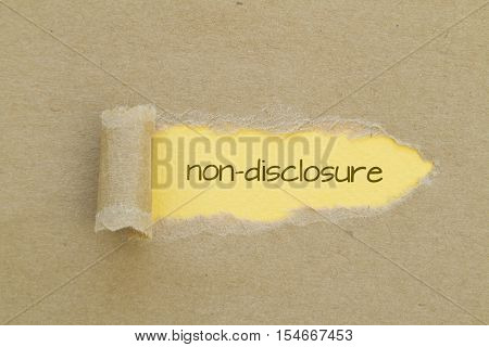 Non-Disclosure word written under torn paper .
