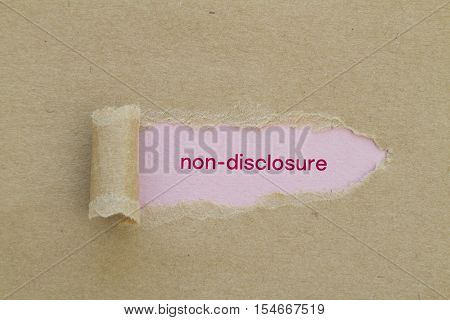 Non-Disclosure word written under torn paper .