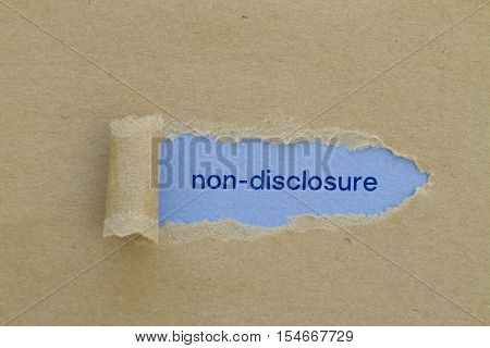 Non-Disclosure word written under torn paper .
