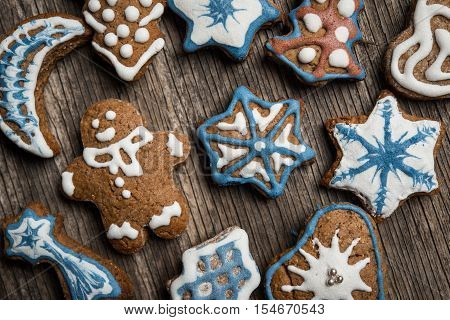 Colorfully Christmas Cookies On Rustic Wooden Background, Gingerman And Tree