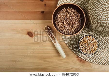 Excellent different cereals on a wooden background.
