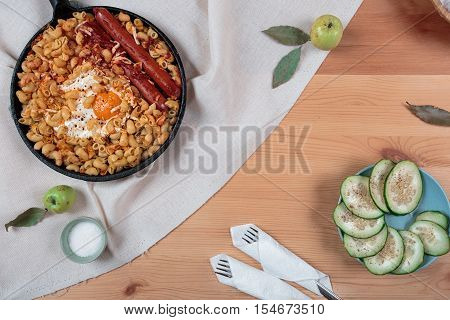 Pasta with egg and green cucumber salad