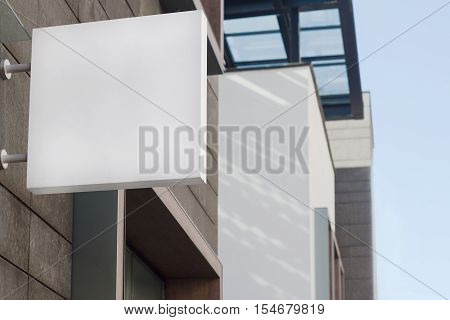 Horizontal front view of empty square signage on a building with modern architecture