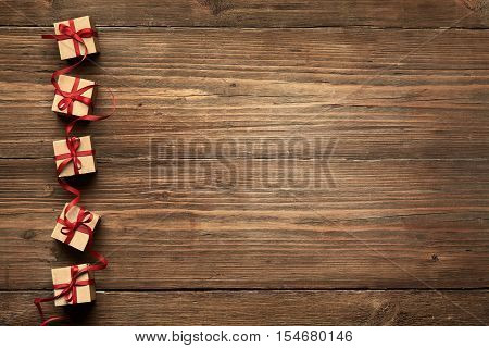 Gift Boxes on Wood Background Christmas Presents Red Ribbon Bow over Wooden Decoration