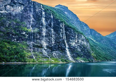 Geiranger fjord Norway: landscape with mountains and waterfalls Seven Sisters.