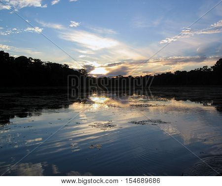 A sunset in a lagoon in the Amazon Jungle in Manu, Peru