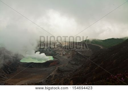 Poas volcano in a heavy dust and fast going clouds, Costa Rica