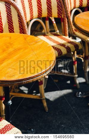 Vintage French cafe table and chairs on Parisian sidewalk