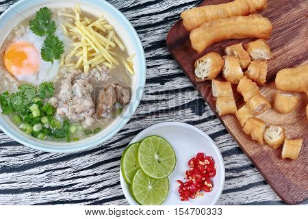 Close up,Rice porridge with mined pork and chicken lever served with side dish as Patongko (deep-fried dough stick) and spicy sour filling.