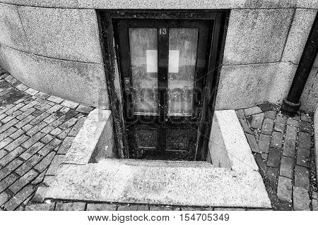 number 13 on the door. old worn door to the apartment in the basement. the concept of horror, mysticism and mystery. triskaidekaphobia and paraskavedekatriaphobia.